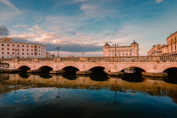 port-of-ortigia-with-prestigious-hotel-in-the-back-2022-06-16-22-32-35-utc